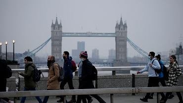 Pandemia koronawirusa. Przechodnie (w maskach i bez) na London Bridge. Anglia, 24 stycznia 2022