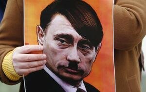 Plakat trzymany przez jednego z protestujących w Rydze przeciwko inwazji Rosji na Ukrainę.  / autor: PAP / EPA